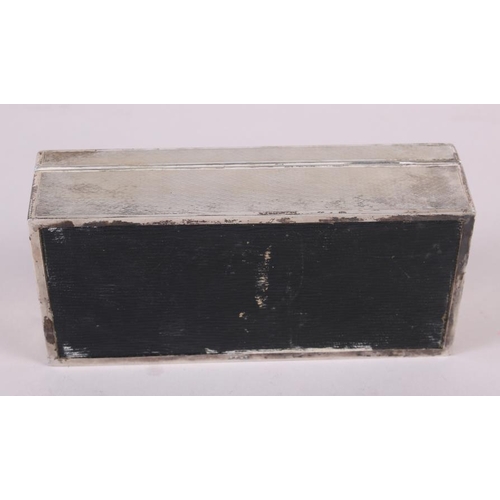 264 - A silver cigarette box with engine turned decoration, 7 1/2