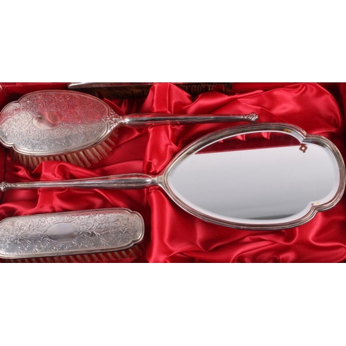 279 - A silver four-piece dressing table set, in fitted case