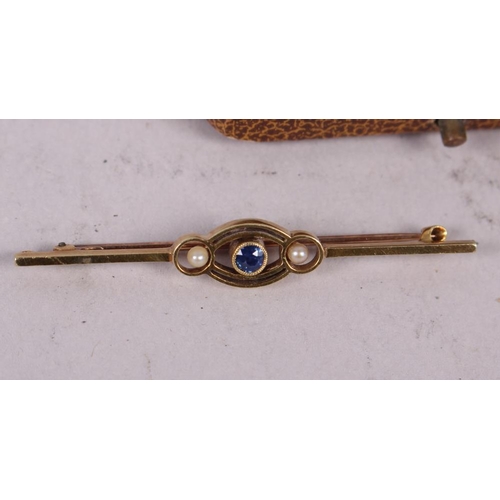 294 - A Victorian yellow metal, stamped 15c, sapphire and seed pearl bar brooch, another Victorian yellow ... 