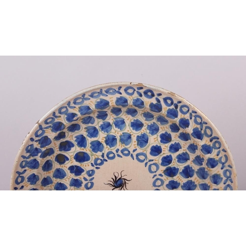 3 - An 18th century Delft plate with all-over leaf and tendril design, 12