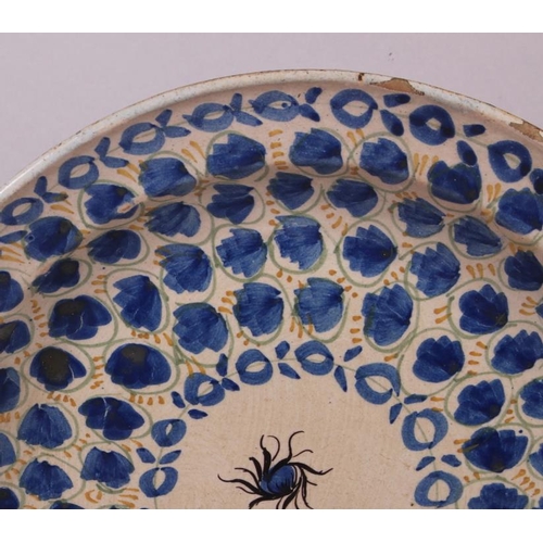 3 - An 18th century Delft plate with all-over leaf and tendril design, 12