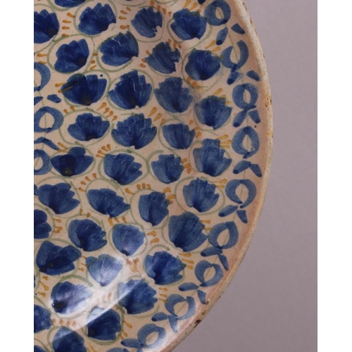 3 - An 18th century Delft plate with all-over leaf and tendril design, 12