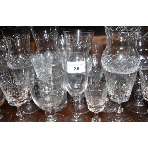 38 - A quantity of table glasses, including wines, scotch and tumblers, a lemonade jug and a tazza