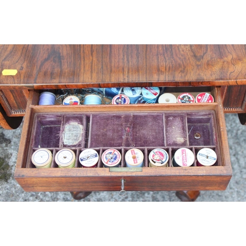 446 - A 19th century rosewood flap top work table, on scrolled qudraform base, 34