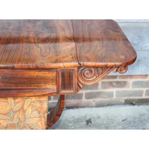 446 - A 19th century rosewood flap top work table, on scrolled qudraform base, 34