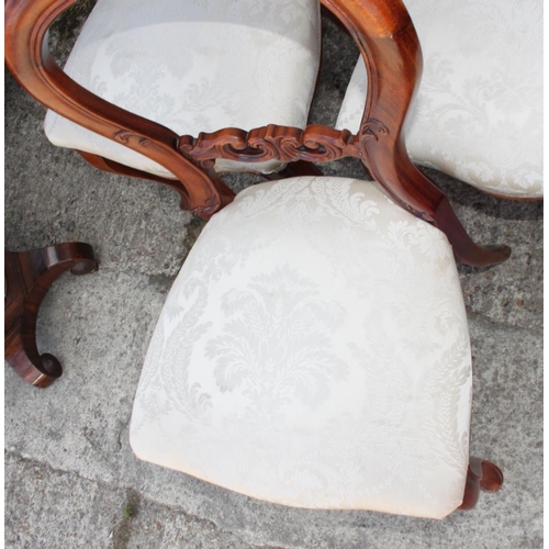 459 - A set of six late Victorian carved mahogany loop back dining chairs with stuffed over seats, on cabr... 