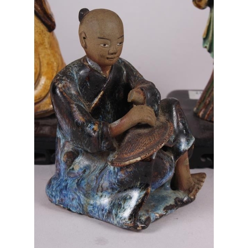 57 - Two Chinese figures, on stands, largest 9 1/2