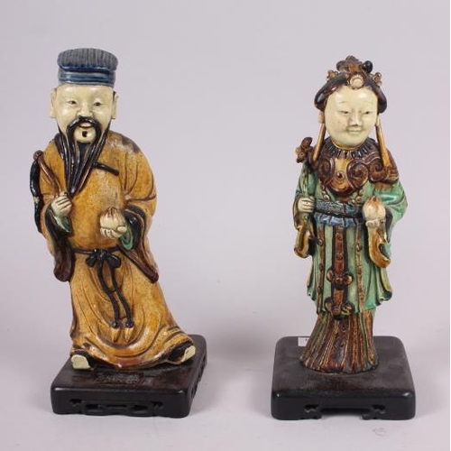 57 - Two Chinese figures, on stands, largest 9 1/2