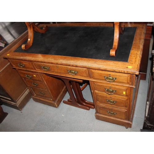 637 - An Edwardian oak double desk with American cloth lined top, fitted nine drawers, on block base, 48