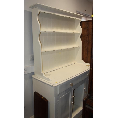 645 - A white painted pine dresser, fitted shelves over two drawers and two cupboards with central recess,... 