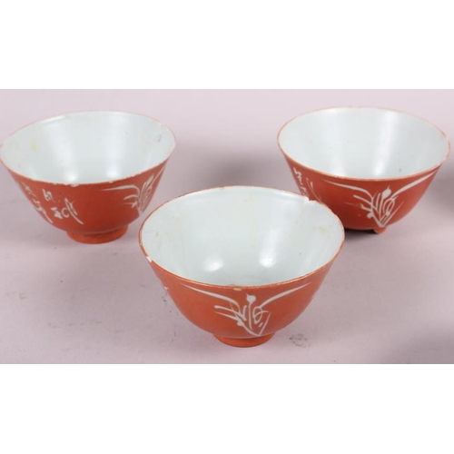 66 - Three Chinese orange glazed tea bowls with seal marks to base, two pairs of tea bowls, and another t... 