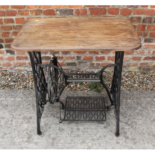 671 - A cast iron sewing machine base, now converted as an occasional table