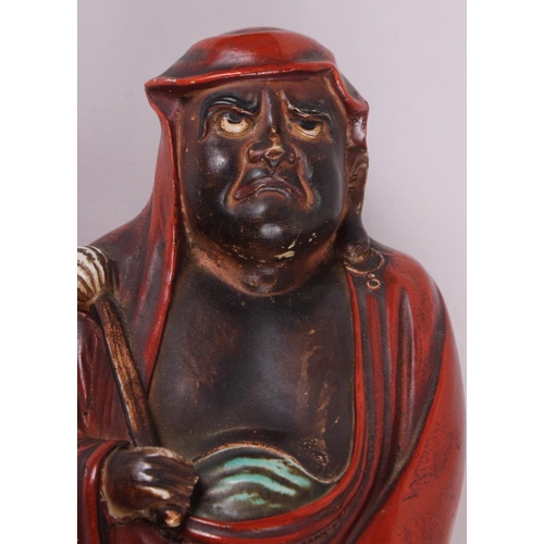 71 - A Chinese porcelain figure of Daruma with a fly whisk, 15