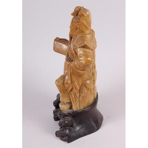 81 - A Chinese soapstone carved figure of an immortal, 11 1/2