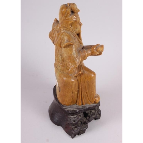 81 - A Chinese soapstone carved figure of an immortal, 11 1/2