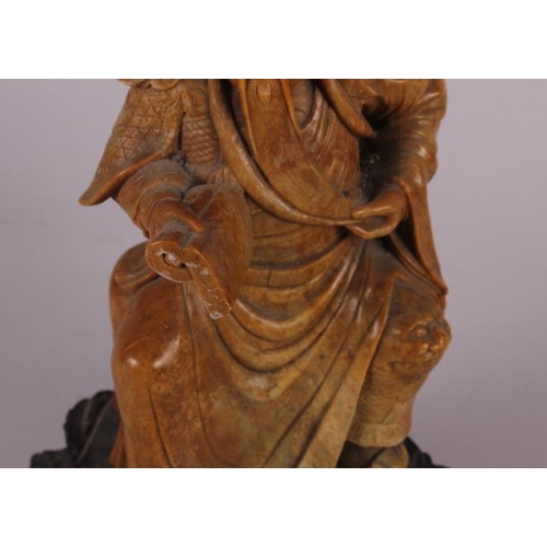 81 - A Chinese soapstone carved figure of an immortal, 11 1/2