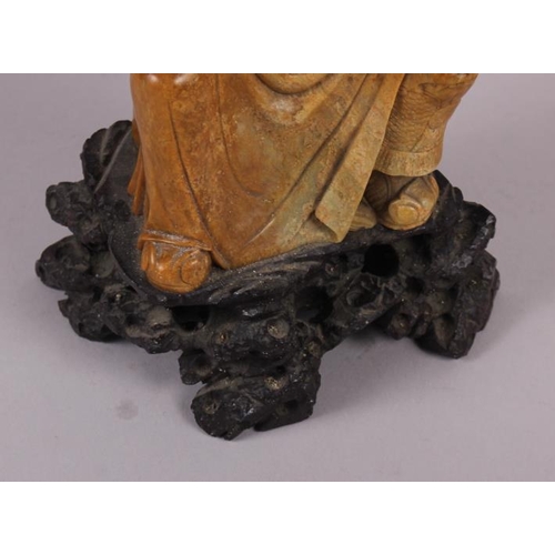 81 - A Chinese soapstone carved figure of an immortal, 11 1/2