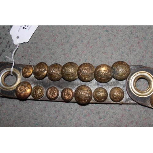 151 - A sectional leather strap mounted with numerous WWII brass buttons, including RASC, Royal Engineers ... 