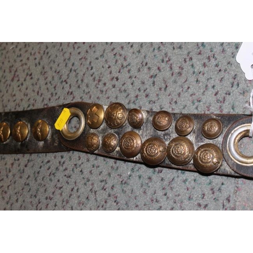 151 - A sectional leather strap mounted with numerous WWII brass buttons, including RASC, Royal Engineers ... 