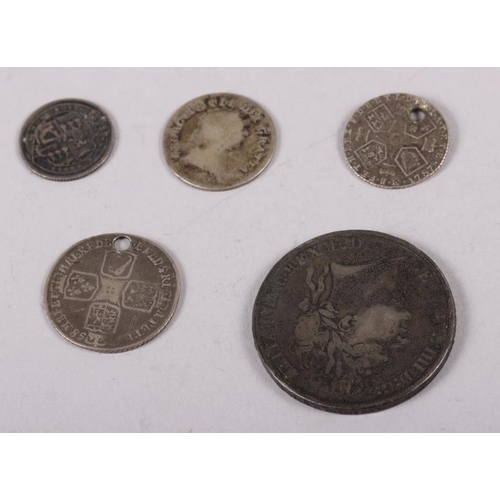 306 - A George IV silver crown, dated 1821, a George III sixpence, dated 1787 (holed), a George III silver... 