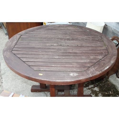 673 - A wooden circular slatted garden table, 41