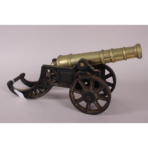 113 - A brass model of a cannon and three similar smaller cannons