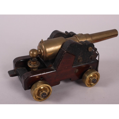 113 - A brass model of a cannon and three similar smaller cannons