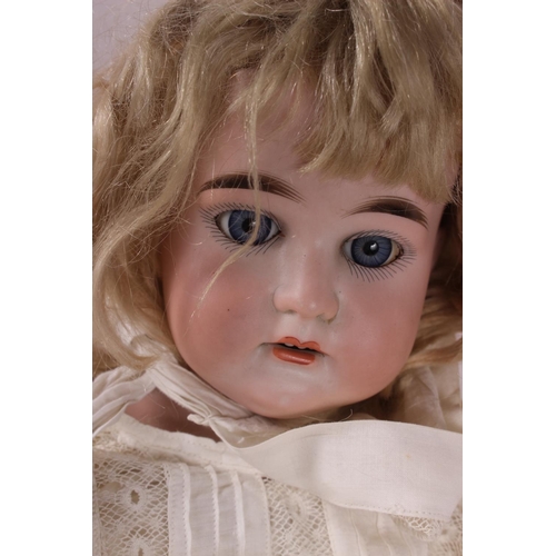 160 - A late 19th century Columbia bisque head doll with kid body and contemporary lace edge clothes, 25