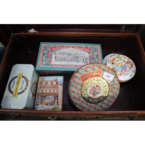 177 - A collection of vintage tins, two tin trunks, a storage box and a leather suitcase