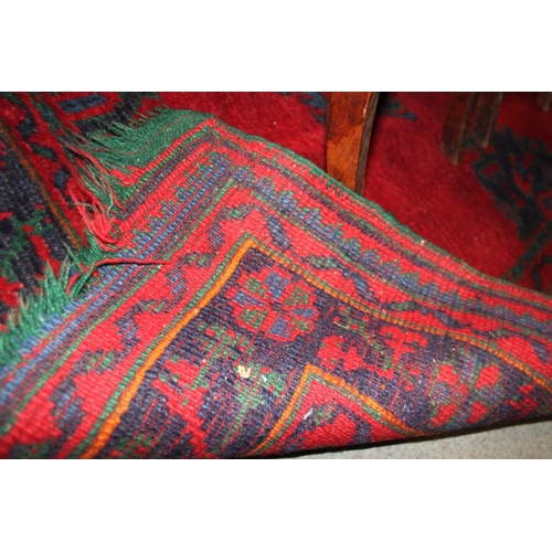 666 - A turkey carpet of traditional design in shades of red, green, blue and yellow, 92