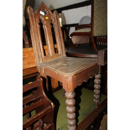 472 - A 19th century oak Gothic design pierced panel back hall chair, on bobbin turned supports