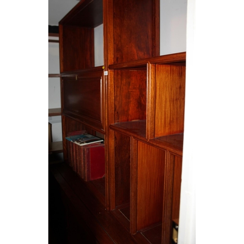 628 - A Chinese hardwood wall unit, fitted open shelves and drop front compartment over three doors, 68