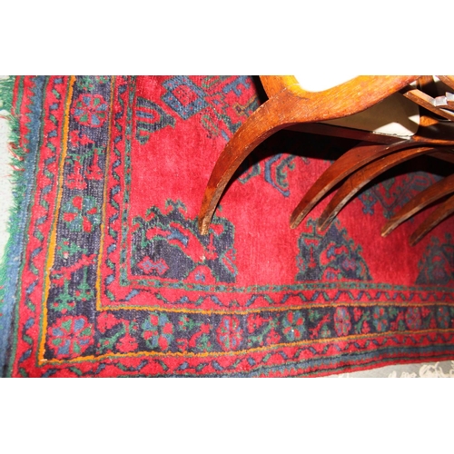 666 - A turkey carpet of traditional design in shades of red, green, blue and yellow, 92