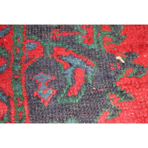 666 - A turkey carpet of traditional design in shades of red, green, blue and yellow, 92