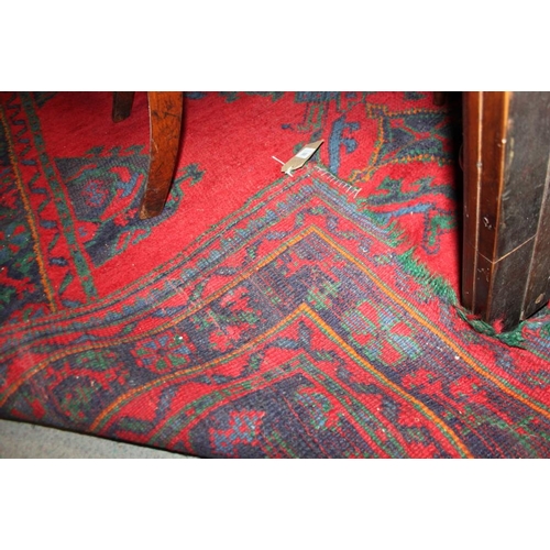 666 - A turkey carpet of traditional design in shades of red, green, blue and yellow, 92