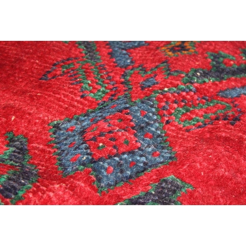 666 - A turkey carpet of traditional design in shades of red, green, blue and yellow, 92