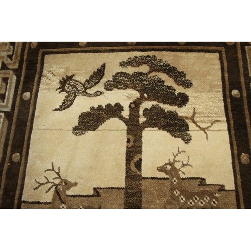 668 - A Chinese rug in shades of brown and beige, rural scenes depicting trees, hills, stags and a rider, ... 