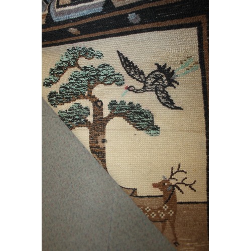 668 - A Chinese rug in shades of brown and beige, rural scenes depicting trees, hills, stags and a rider, ... 