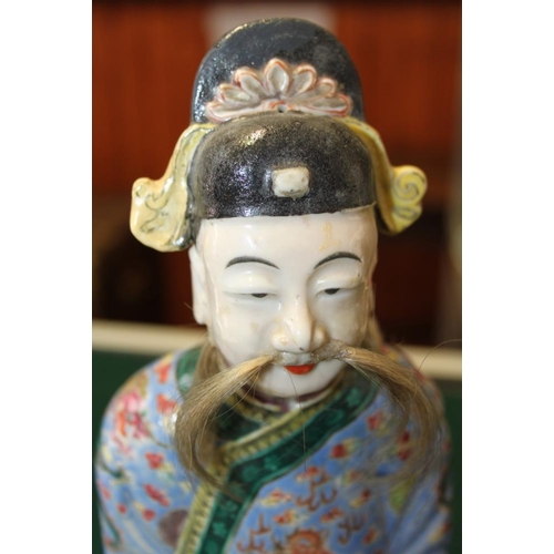 64 - A Canton enamel figure of the God of Fortune, 10