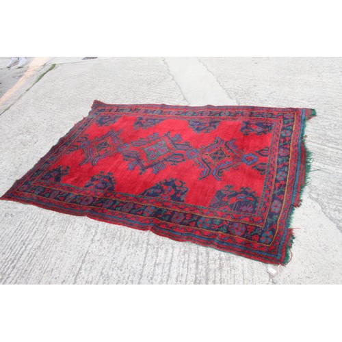 666 - A turkey carpet of traditional design in shades of red, green, blue and yellow, 92