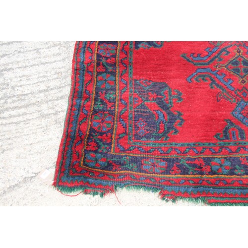 666 - A turkey carpet of traditional design in shades of red, green, blue and yellow, 92