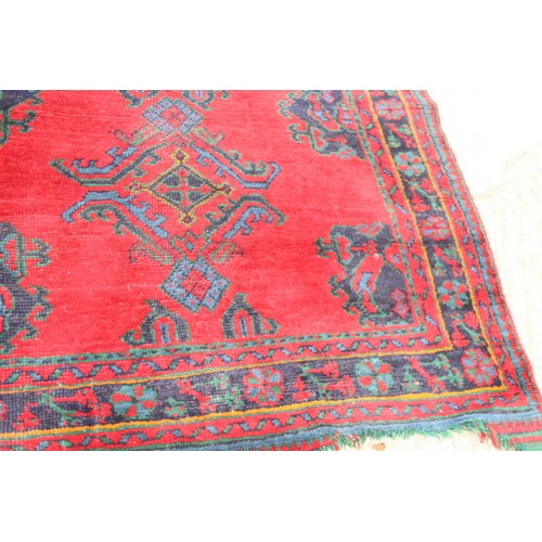 666 - A turkey carpet of traditional design in shades of red, green, blue and yellow, 92