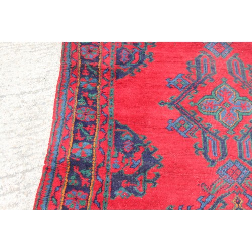 666 - A turkey carpet of traditional design in shades of red, green, blue and yellow, 92