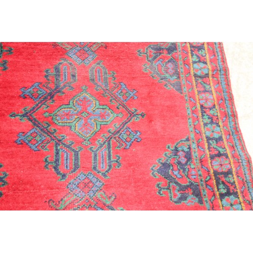 666 - A turkey carpet of traditional design in shades of red, green, blue and yellow, 92