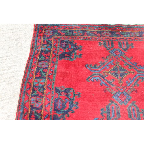 666 - A turkey carpet of traditional design in shades of red, green, blue and yellow, 92