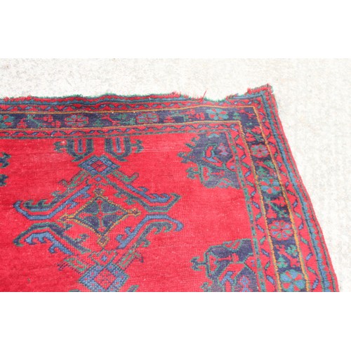 666 - A turkey carpet of traditional design in shades of red, green, blue and yellow, 92