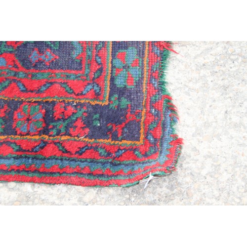 666 - A turkey carpet of traditional design in shades of red, green, blue and yellow, 92