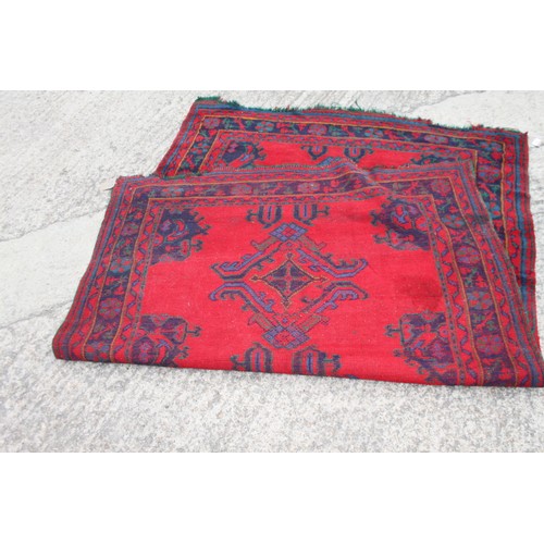 666 - A turkey carpet of traditional design in shades of red, green, blue and yellow, 92