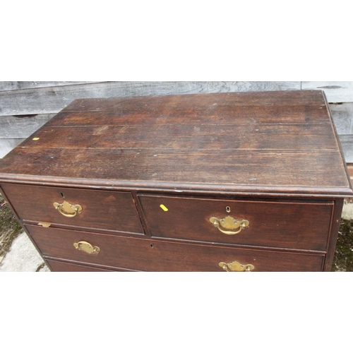 516 - A Georgian provincial oak chest of two short and two long graduated drawers, on bracket feet, 44