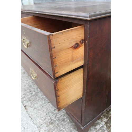 516 - A Georgian provincial oak chest of two short and two long graduated drawers, on bracket feet, 44